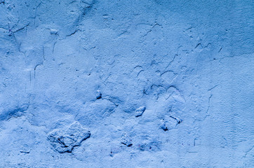 Abstract grunge texture - old battered wall with potholes.