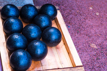 Old gray cannonballs lie on the ground