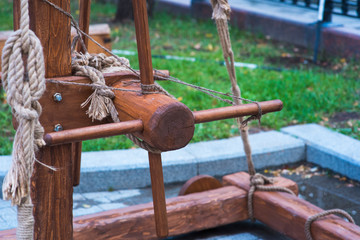 Ancient catapult close up. Defensive wall. Catapult in the downtown of the citywith the sea as background and the big stone bullets in front