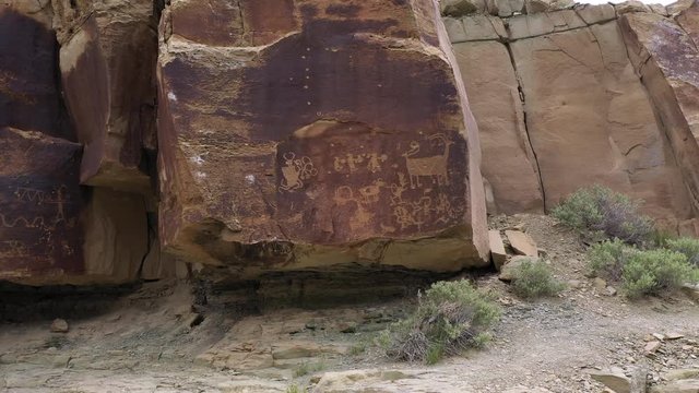 Rotating around rock with petroglyphs on the edge of them in Utah's Nine Mile Canyon.