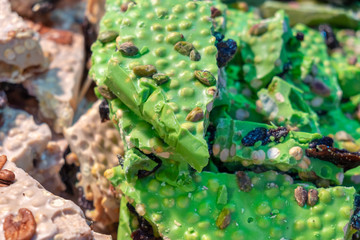 Homemade pistachio green chocolate for sale at Krakow christmas market