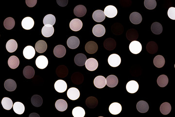 Abstract bokeh of white city lights on black background. defocused and blurred many round light