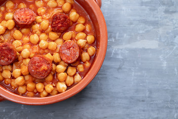 chick pea with smoked sausage in ceramic dish