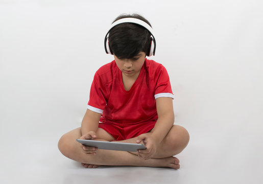 Young Boy Plays With His Tablet Isolated On White Background