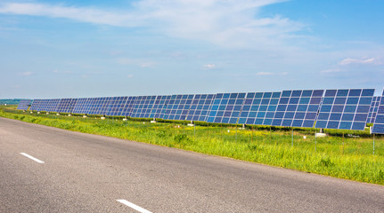 Solar station. Solar panels for the production of natural solar energy along the road. Green...