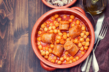spanish sausage with chick-pea in ceramic dish