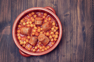 spanish sausage with chick-pea in ceramic dish