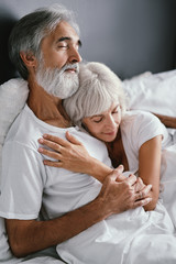 Happiness and tender. Senior family. Husbang hugging his wife in bed.