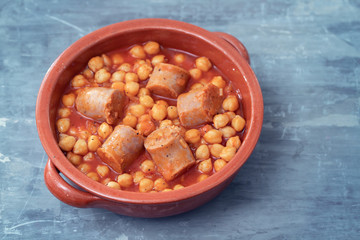 chick-pea with sausage in ceramic pot