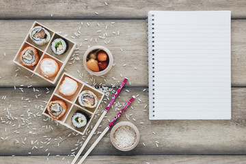 Flat lay sushi composition with notepad template