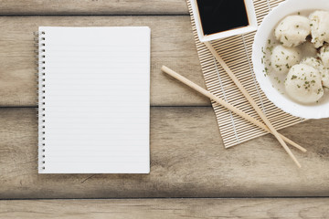 Obraz na płótnie Canvas Flat lay asian food composition with notebook