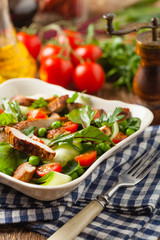 Delicious salad with grilled veal, beetroot and cucumber. Front view.