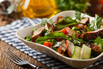 Delicious salad with grilled veal, beetroot and cucumber. Front view.
