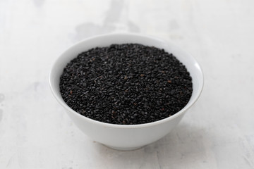 seeds of black sesame in the white bowl