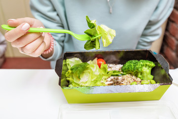 Happy woman eating healthy broccoli salad