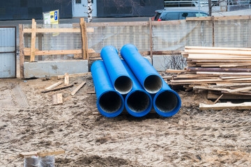 Big blue water pipes on the construction site.Repair of water supply networks