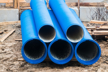 Big blue water pipes on the construction site.Repair of water supply networks