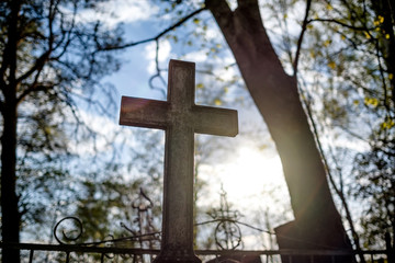 Silhouette the cross on sunset at cemetry