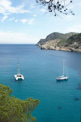 Fototapeta na wymiar Landscapes of the island of Ibiza. Yachts in the sea bay.