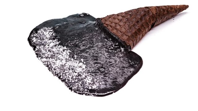 reverse of side view chocolate flavor ice cream cone with shredded coconut melting on white time lapse