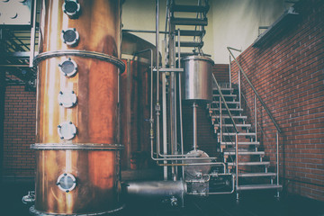 Industrial equipment for brandy production..Copper still alembic inside distiller to distill grapes...