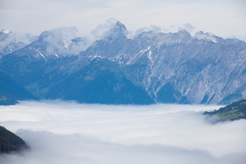 Fototapeta na wymiar Mountain view with valley covered in clouds in Montafon Austria