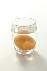 Egg in water in glass