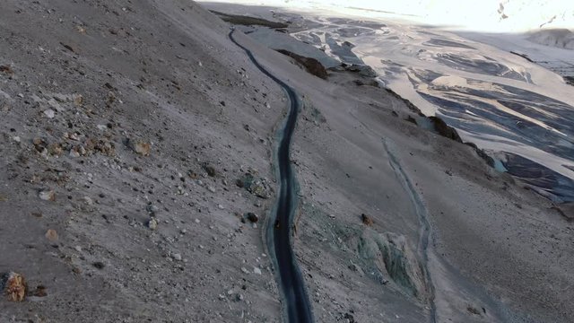 4k aerial fly over road with motorbikers in dry mountain area in Ladakh in India