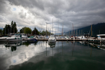Fototapeta na wymiar Boats Yachts and Sailboats in a Sea Port.
