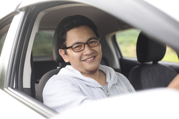 Young Asian Driver Man Smiling