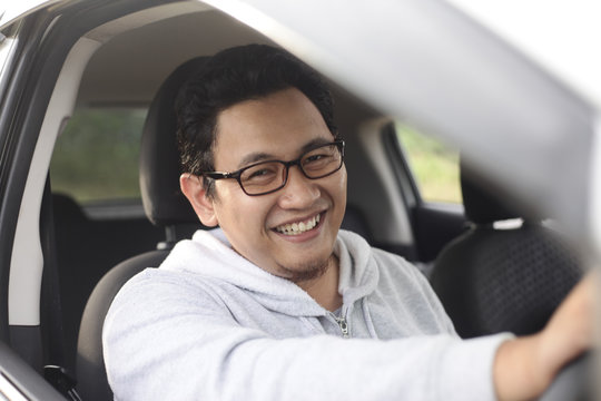 Young Asian Driver Man Smiling