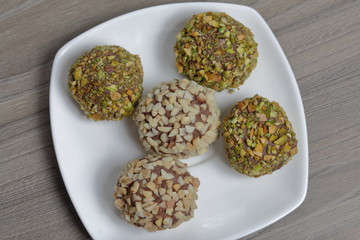 Homemade sweets. Chocolate truffles with a crumb of peanuts and pistachios.