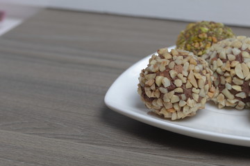 Homemade sweets. Chocolate truffles with a crumb of peanuts and pistachios.
