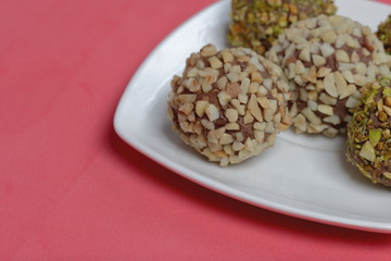 Homemade sweets. Chocolate truffles with a crumb of peanuts and pistachios.