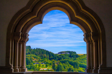 Fototapeta na wymiar View of the mountain and forest in Vianden, Luxembourg, from an arch inside the Vianden Castle