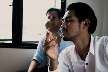 World No Tobacco Day in May, stop smoking and against  concept, young man choking of smoke  as...
