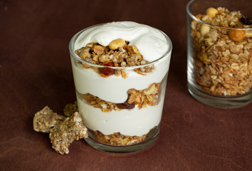 Healthy breakfast with granola and homemade yogurt in a glass. Rustic style	