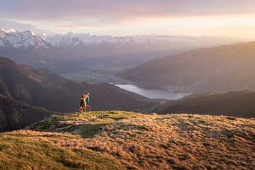 Male mountainbiker on a trail in the mountains at sunset