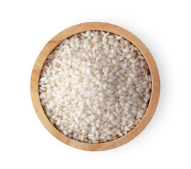 white rice in wood bowl isolated on white background. top view