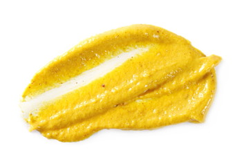 Yellow mustard sauce, spread isolated on white background, top view