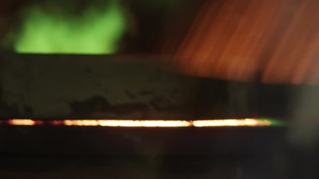 Green flames come out of oven in foundry
