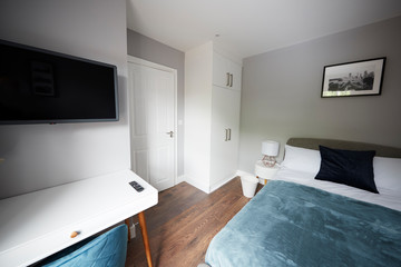 Bedroom in a modern house, looking towards door