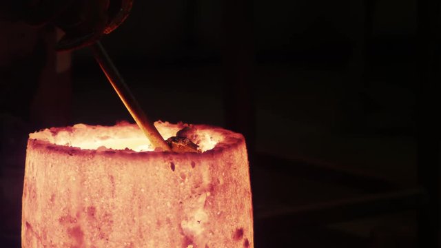 metal slough gets pulled out of crucible while heating bronze