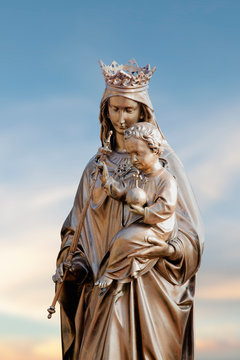 Queen of Heaven. Ancient statue of the Virgin Mary with Jesus Christ
