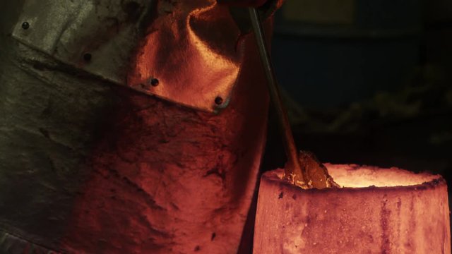 metal slough gets pulled out of crucible while heating bronze