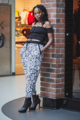 Young dark-skinned woman dressed in casual clothes in the mall