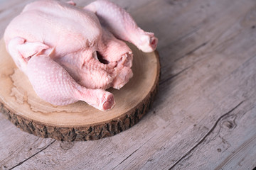 Raw chicken on wooden table with copy space .. Food.