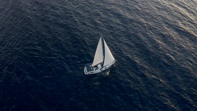 Yacht sailing on opened sea. Flight Sail and Ship. Sailing boat. Yachting Aerial 4k video. Yacht from above. Sailboat from drone. Sailing video. Yachting at windy day.