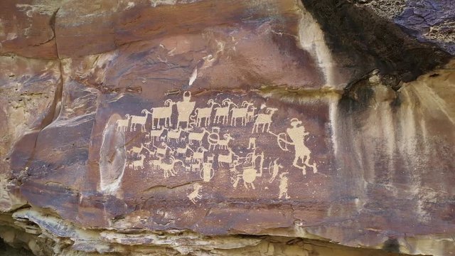 Petroglyphs in 9 Mile Canyon in Utah at the Great Hunt Panel rotating around the cliff.