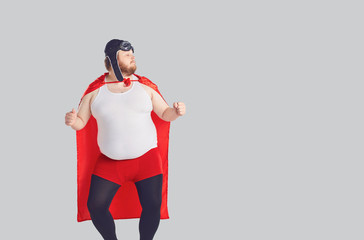 Funny fat man in a superhero costume dancing